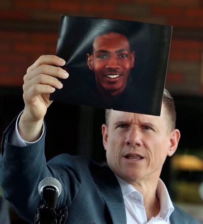 Attorney Bobby DiCello, representing the family of Jayland Walker, holds up a photograph of the dead man. AP)