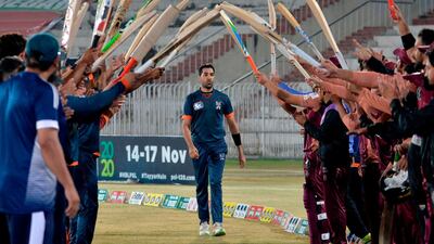 Teammates and opponents give a guard of honour to Pakistani cricketer Umar Gul during the National T20 Cup in Rawalpindi on October 16, 2020. AFP