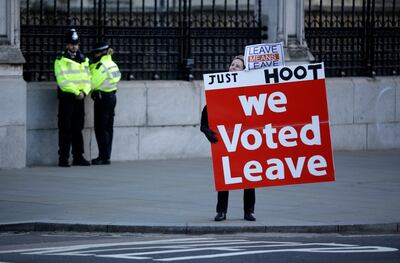 A pro-Brexit demonstrator holds a banner outside the Houses of Parliament in London. AP Photo