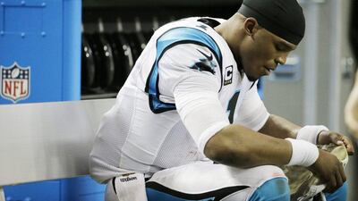 Carolina Panthers quarterback Cam Newton sits on the bench during his team's NFL loss to the Atlanta Falcons on Sunday. David Goldman / AP / December 27, 2015