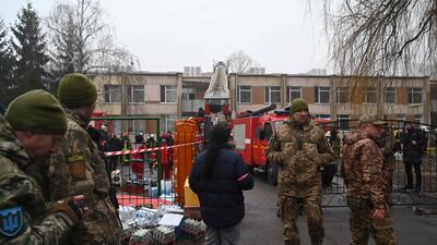 Military personnel and rescue workers near the crash site. AFP