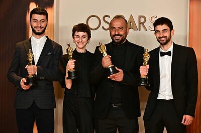 From left; Basel Adra, Rachel Szor, Hamdan Ballal and Yuval Abraham with their Oscar for Best Documentary Feature for No Other Land. AFP