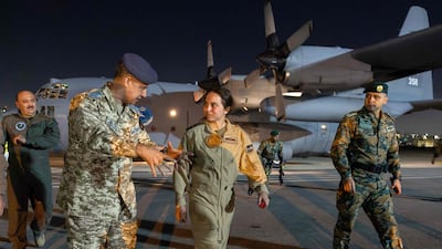 Princess Salma of Jordan, daughter of King Abdullah II and Queen Rania, is briefed by officers upon returning to Marka military airport. All photos: AFP