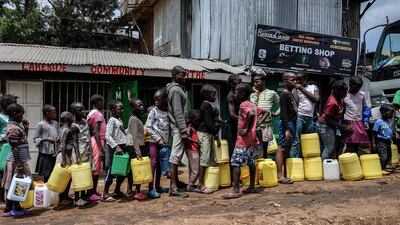 Children queue with their jerrycans to fill them with free water distributed by the Kenyan government at Kibera slum in Nairobi, Kenya. AFP