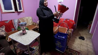 Hajja Dalal prepares her drum at home, before going out to wake up Muslims to have the predawn meal before they start their long-day fast during Ramadan, at Maadi neighbourhood in Cairo, Egypt. Reuters