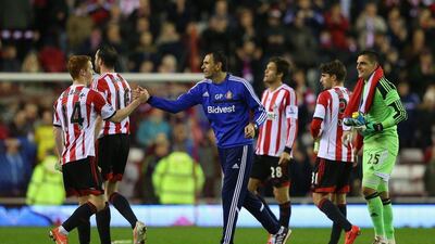 Sunderland manager Gus Poyet celebrates with Jack Colback and his players after avoided Premier League relegation on Wednesday with a win over West Bromwich Albion. Alex Livesey / Getty Images / May 7, 2014