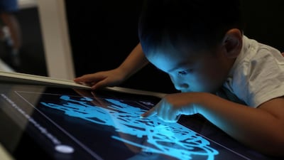Ryan, 2, visits the children's museum at Louvre Abu Dhabi on Sunday. Chris Whiteoak / The National