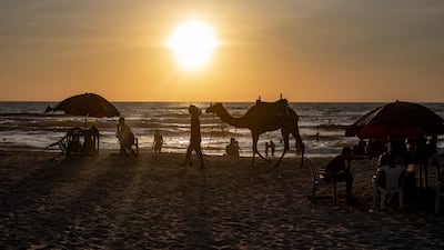 Palestinian families on the beach in Gaza city after the Israeli army banned fishing and swimming in the Mediterranean Sea off the city. EPA