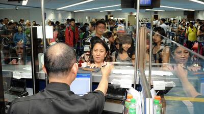 Filipinos at Manila airport, where millions of them face scrutiny by emigration officials before being allowed to travel abroad to work. Jay Directo / AFP
