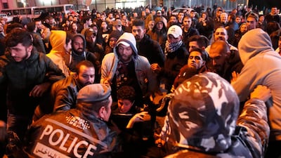 Lebanese policemen try to remove anti-government protesters to reopen a main road that was closed during ongoing protests against corruption and financial crisis, in Beirut, Lebanon. AP