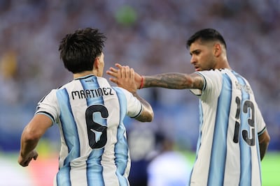 Lisandro Martinez celebrates with Cristian Romero, his partner in a palo santo wood-burning ritual, after scoring against Cape Verde. Getty Images