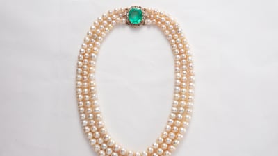 A Victorian three-strand pearl necklace with an emerald clasp