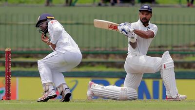 Sri Lanka's Kusal Mendis, left, reacts after a shot played by India's Shikhar Dhawan, right, during the first day of the third Test. Dhawan would go on to hit a century.
