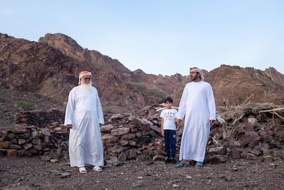 Three generations of the Al Mazroui family. Obaid Al Mazroui, 71, with his grandson by the same name, and son, Saif, 39. Reem Mohammed / The National