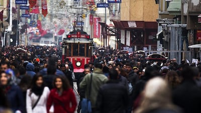 An old tram passes crowds of pedestrians walking along Istiklal Avenue on the European side of Istanbul on February 27, 2014. Kerim Okten/Bloomberg