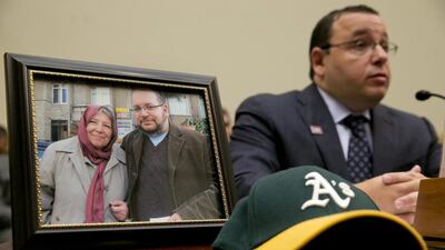 Ali Rezaian, brother of the Washington Post journalist Jason Rezaian, testifies before the US House foreign affairs committee on June 2, 2015, beside a photograph of Jason and their mother. Jacquelyn Martin / AP Photo
