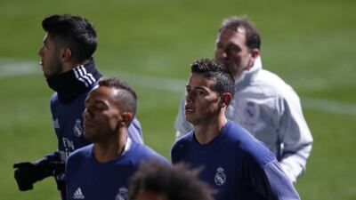 James Rodriguez, right, and teammates warm up. Yuya Shino / EPA