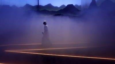 Visitors follow a foggy path to the summit of the Swiss pavilion. Pawan Singh / The National