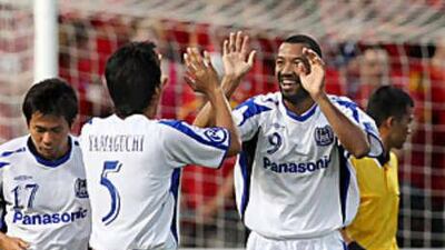 Gamba Osaka's Lucas, right, celebrates sealing the title for the Japanese team with his second goal of the night.