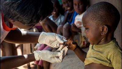 A health worker from Living Goods, one of the Zayed Sustainability Prize finalists, delivers medication to a child in Africa. The project manages 8,700 community health workers in Kenya and Uganda. Courtesy Zayed Sustainability Prize