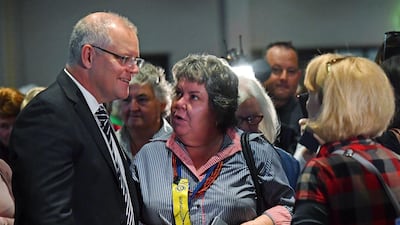 Australian Prime Minister Scott Morrison, left, talks with attendees at the Country Women's Association in rural New South Wales. The leader was hit on the head with a egg. Mick Tsikas / AAP Image via AP