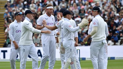 England bowler Stuart Broad, third left, celebrates with teammates following the dismissal of India's Cheteshwar Pujara for 66. AP