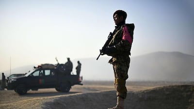 Afghan security forces keep watch at the site of a suicide attack on the outskirts of Kabul on December 18, 2014. Shah Marai/AFP Photo