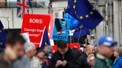 Pro and anti-Brexit supporters hold signs and flags while demonstrating outside the UK parliament in September, 2019. AP