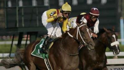 The jockey Robby Albarado celebrates aboard Curlin, left, after holding off Past the Point to win the Woodward Stakes at Saratoga.