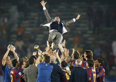 Barcelona players throw coach Pep Guardiola in the air after defeating Estudiantes in the 2009 Club World Cup final in Abu Dhabi. Reuters