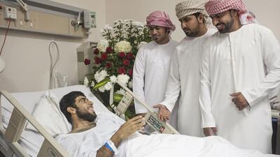 Abdulaziz Al Bloushi, 27, surrounded by his family. Mona Al Marzooqi / The National
