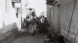 Drummer Khamees, an Abu Tabla, walks the alleyways of Abu Dhabi with his entourage to wake people for the day’s fasting in the 1970s. Photo: Al Itihad