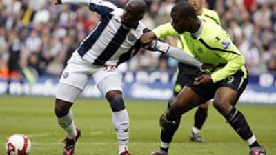 Fortune is tugged by Wigan's Titus Bramble.