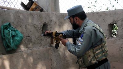An Afghan security official guards the UN office in Herat, Afghanistan, on July 31, 2021. The office had been attacked by 'anti-government elements' the previous day.