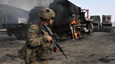 In this 2014 photo, a US soldier investigates the scene of a suicide attack at the Afghan-Pakistan border crossing in Torkham, Nangarhar province. Endless wars in Afghanistan, Syria and Libya, and ongoing conflict in Iraq, have justified the realists' stance against foreign interventions. AFP