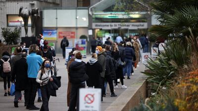 People queue to receive Covid-19 vaccines and booster doses at a walk-in vaccination centre at St. Thomas' Hospital in London. Reuters