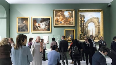 Visitors at an exhibition in Louvre Abu Dhabi. The UAE capital is creating a Dh600 million fund to attract business and leisure events. Christopher Pike / The National