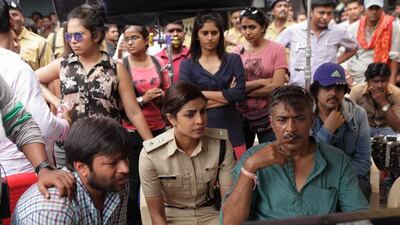 Priyanka Chopra, centre, with director Prakash Jha, right, on the set of Jai Gangaajal. Courtesy Prakash Jha Productions