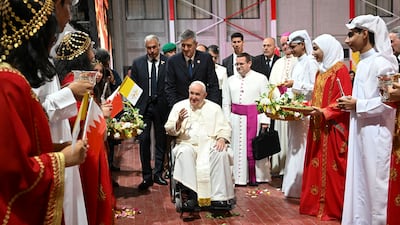 Pope Francis is welcomed by girls and boys in traditional dress during a meeting with young people in Sacred Heart School in Manama, Bahrain. EPA