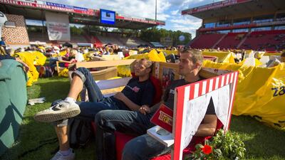 People sit on sofas as they watch a 2014 World Cup match at Berlin Union's Alte Forsterei stadium, where public viewings of the World Cup are being held in a vast 'World Cup living room'. Thomas Peter / Reuters