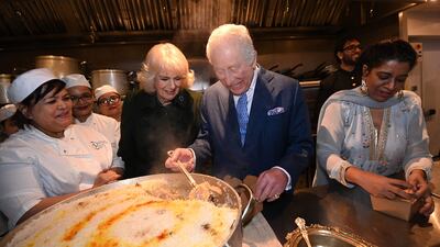 King Charles and Queen Camilla also visited the Indian restaurant Darjeeling Express, where they helped pack donation boxes of rice. AFP