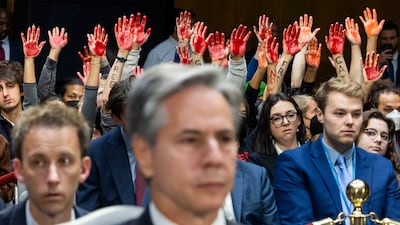 Protesters calling for a ceasefire in Gaza raise their arms as US Secretary of State Antony Blinken testifies in Washington last October. EPA