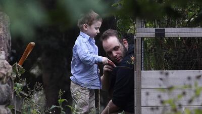Joshua Boyle and son Jonah play in the garden at his parents' house in Smiths Falls, Ontario, on Saturday, October 14, 2017. Lars Hagberg / The Associated Press
