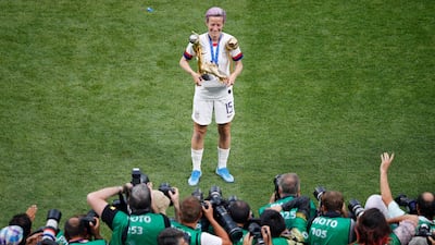 Rapinoe poses in front of photographers. AP Photo