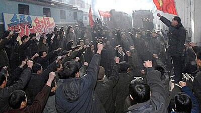 Workers at the Kim Jong Tae Electric Locomotive Combined Plant honour Kim Jong-il in Pyongyang yesterday.