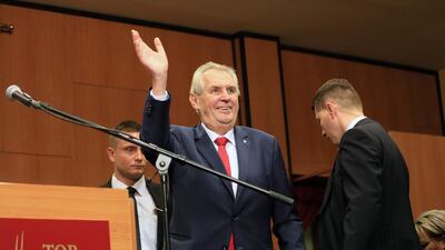 Pro-Russian incumbent Milos Zeman waves as he arrives to celebrate his victory with his staff members after he was reelected Czech President. AFP PHOTO / RADEK MICA