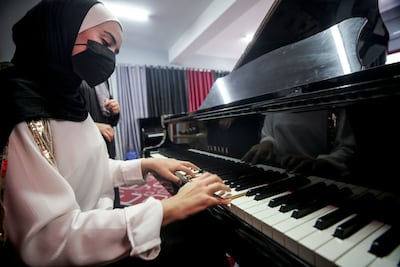 A student plays on Gaza's only grand piano at the Edward Said National Conservatory of Music in Gaza. Mustafa Mohamad for The National