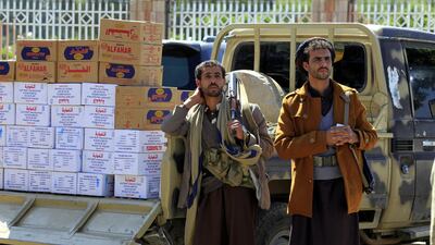 Armed supporters of Houthi rebels stand near a car carrying food supplies during a gathering to collect food aid and mobilise more fighters into Hodeidah battlefronts, in Sanaa. EPA