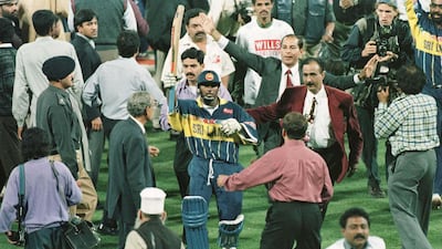 Aravinda De Silva raises his bat as he comes off the field after leading Sri Lanka to victory. Getty Images