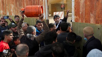 Gazans gather at the Rafah border crossing to receive fuel during a pause in the war. Reuters